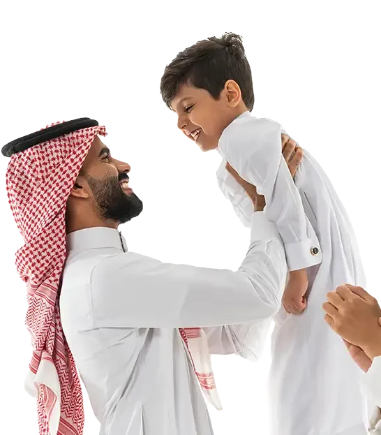 an image of a Saudi family, with the father holding the his son up